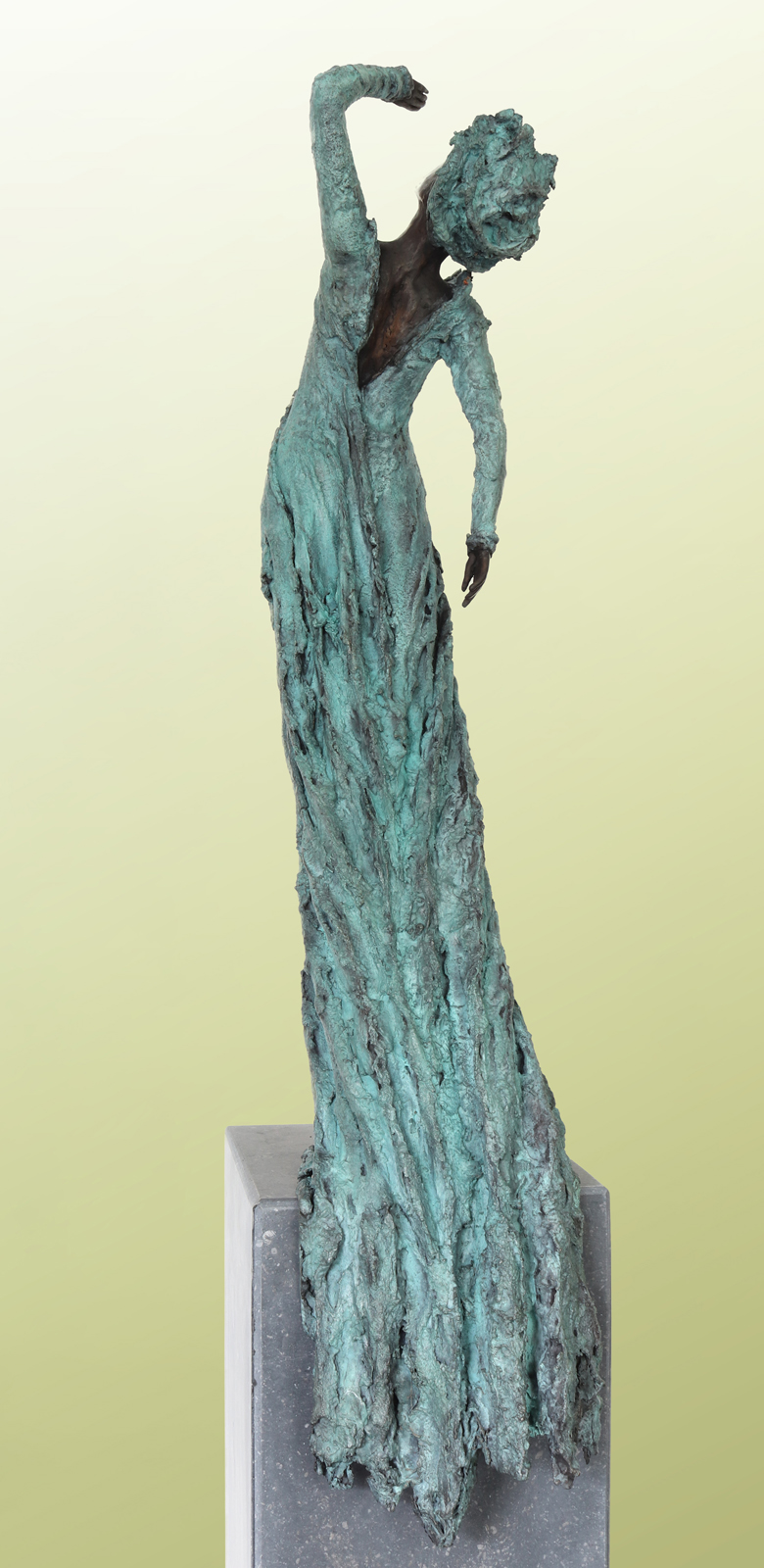Tall sculpture of a slender, textured figure with turquoise patina, arm raised overhead, standing on a gray pedestal against a pale gradient background.